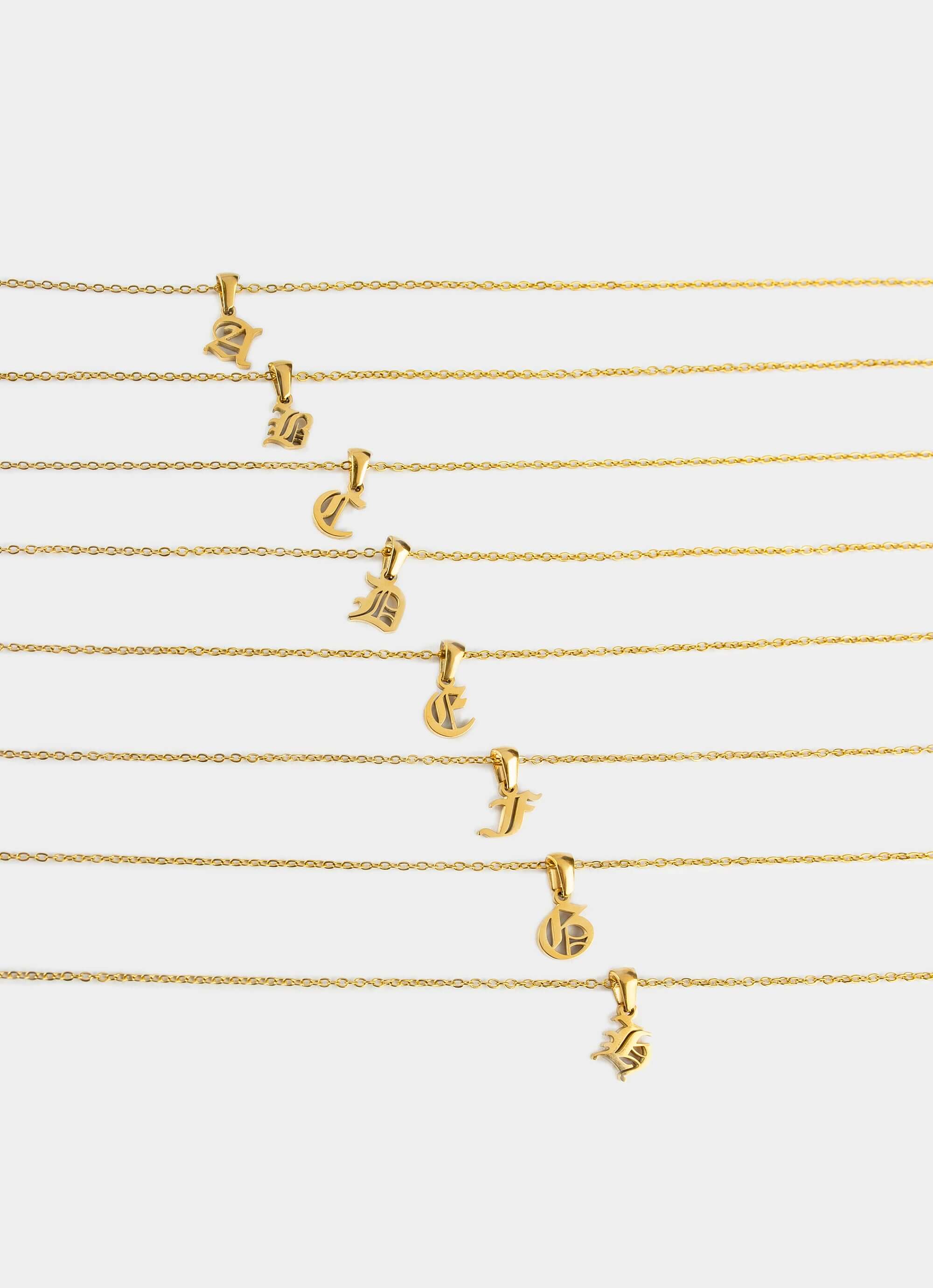 gold plated necklace – multiple letter pendants – Vendetta Jewellery